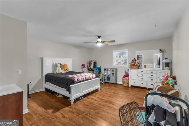 a bedroom with a bed and a flat tv screen on dresser