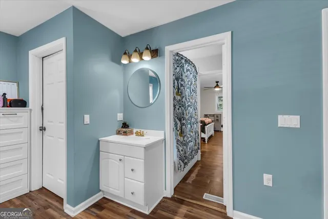 a hallway with front door wooden floor and windows