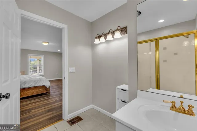 a bathroom with a double vanity sink and mirror