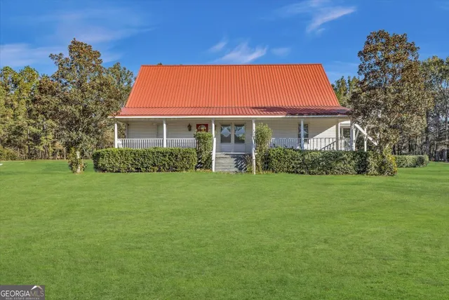 a view of house with backyard