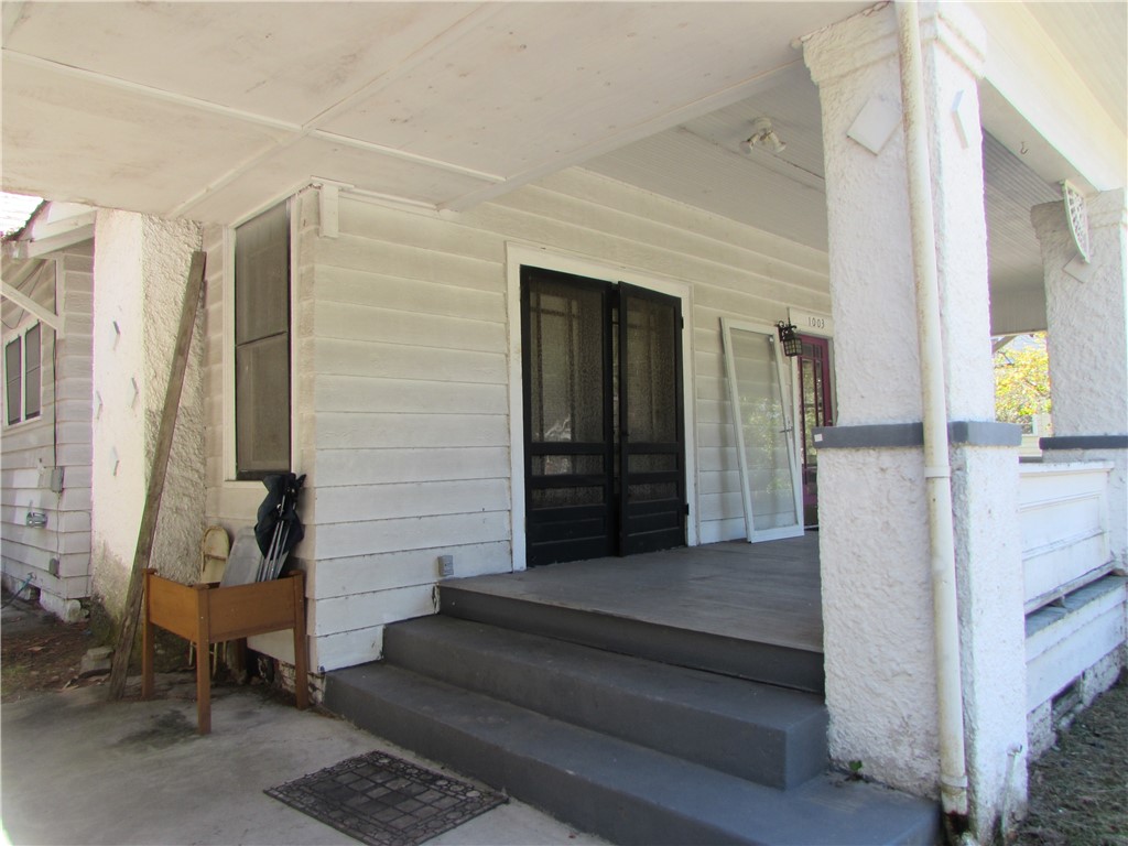 1003 Carswell Avenue Waycross, GA 31503 - Photo 4 of 25 The wide front porch has these double French doors into the dining room
