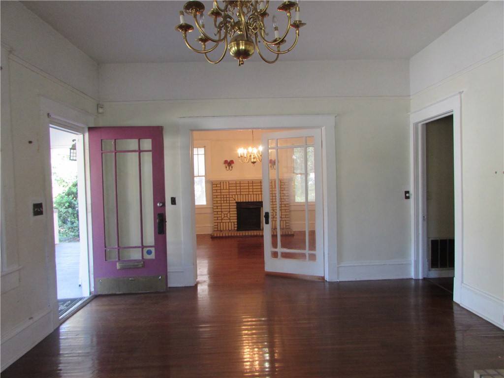 1003 Carswell Avenue Waycross, GA 31503 - Photo 8 of 25 Living room and front door. Looking through to the dining room.