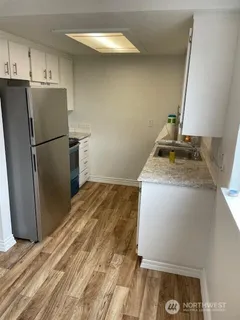 a kitchen with a refrigerator and a stove