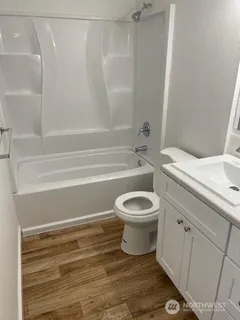 a bathroom with a toilet a sink and bathtub