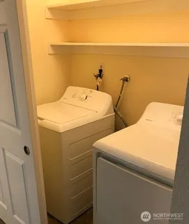 a bathroom with a granite countertop bathtub shower sink vanity and toilet