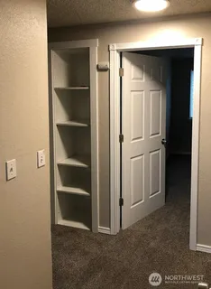 a view of an empty room with closet