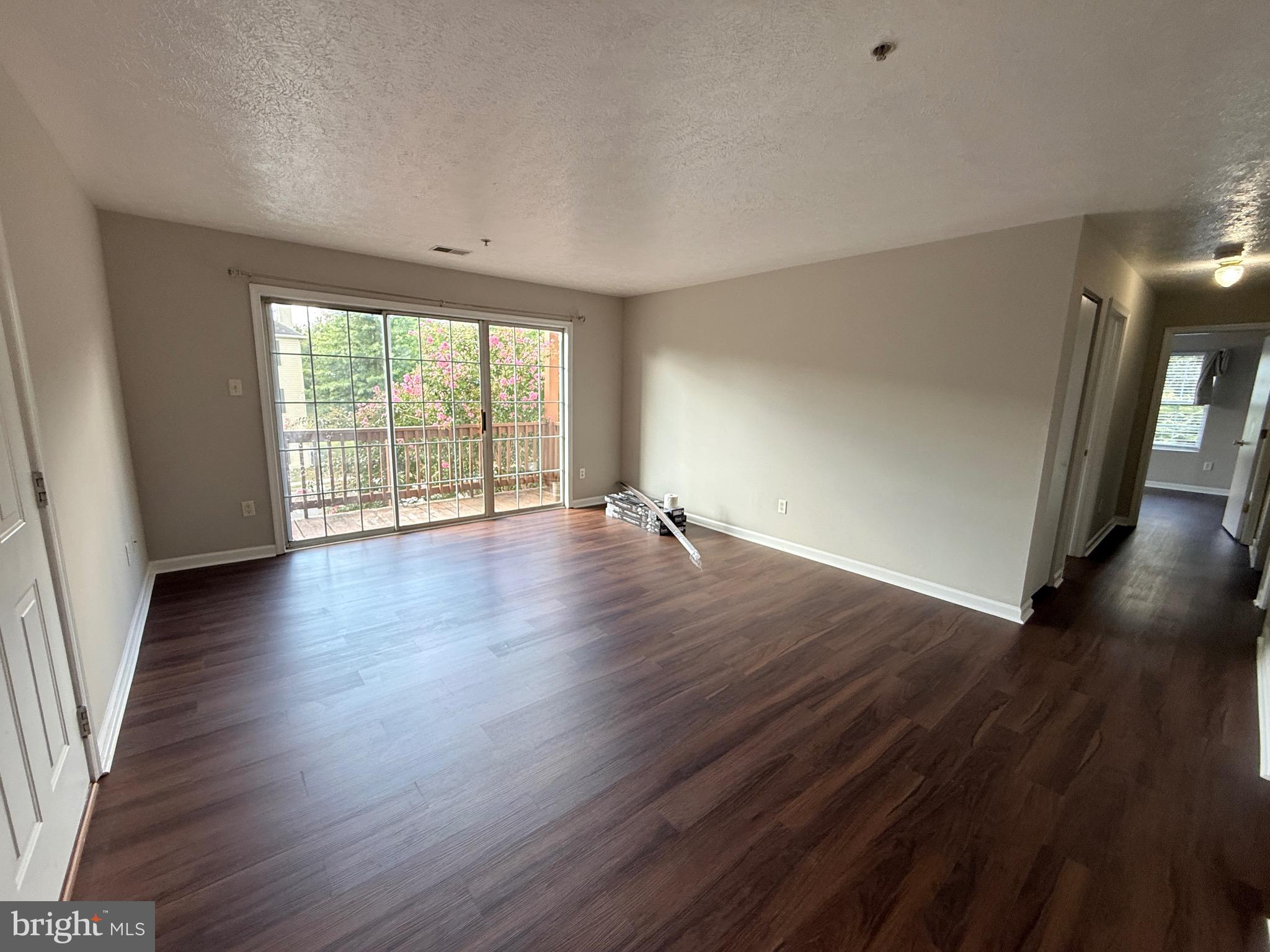 129-8 Brookland Terrace, Unit 8 Winchester, VA 22602 - Photo 2 of 10 an empty room with wooden floor and windows