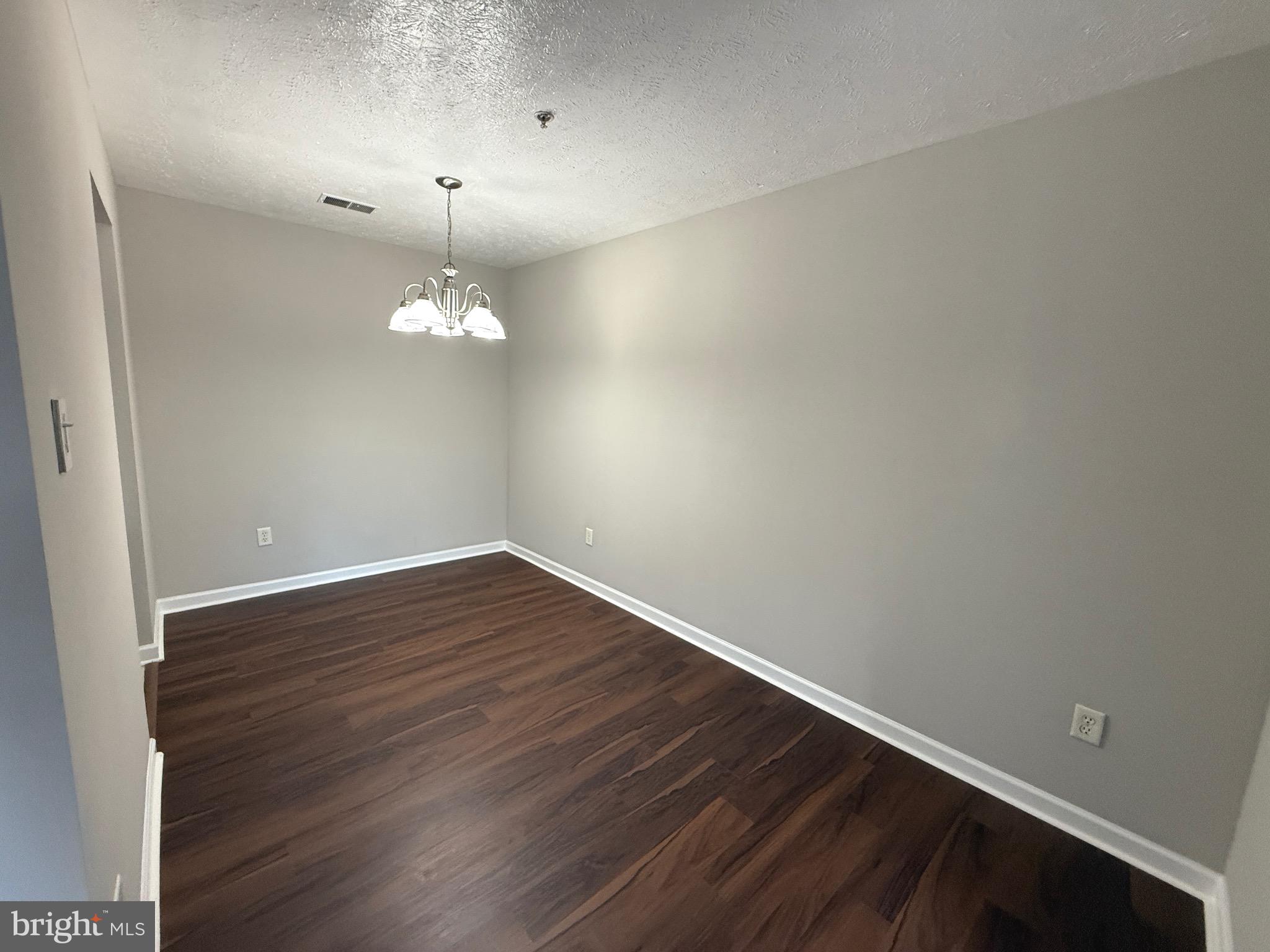 129-8 Brookland Terrace, Unit 8 Winchester, VA 22602 - Photo 4 of 10 a view of a room with wooden floor and fan