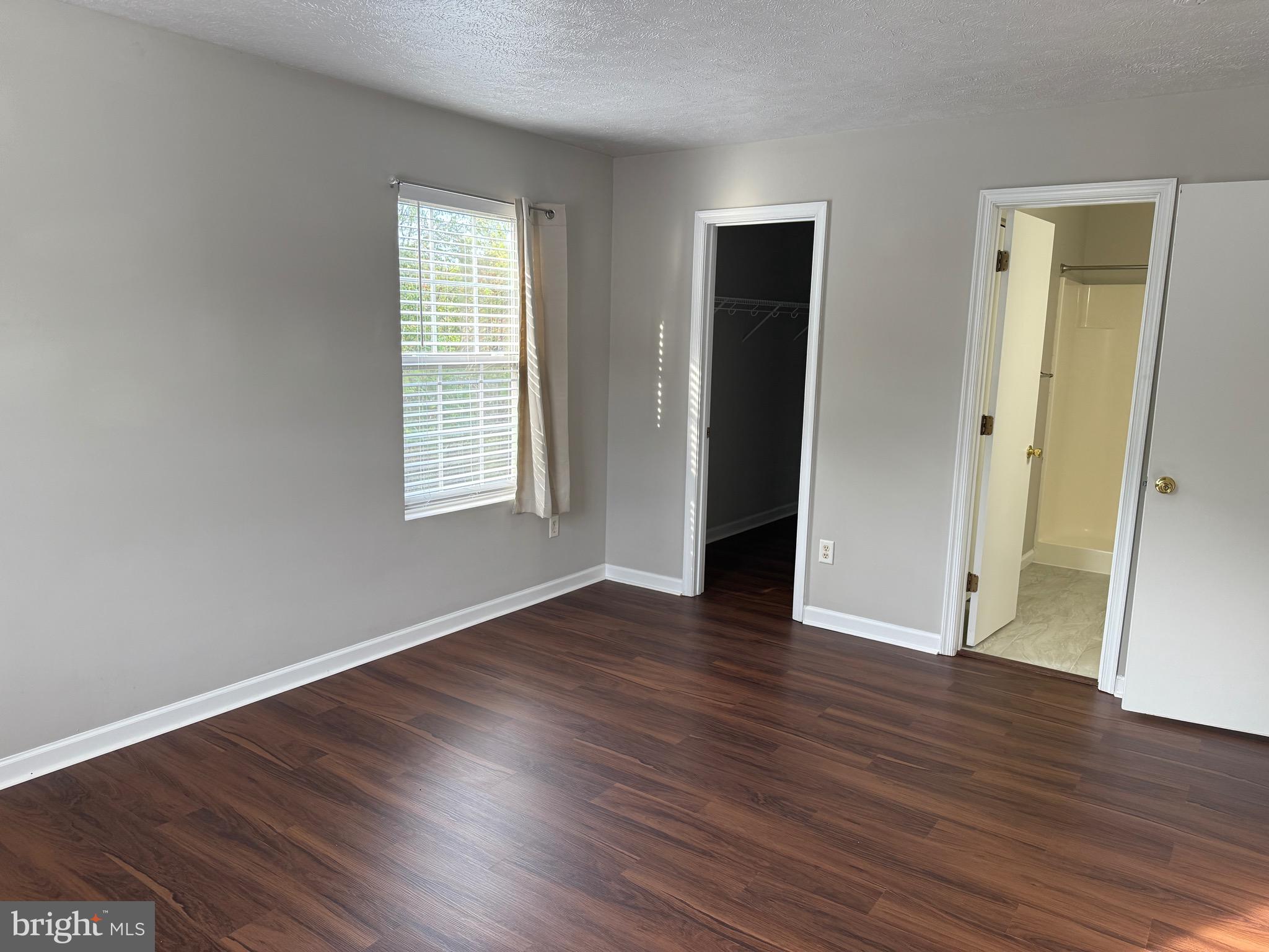 129-8 Brookland Terrace, Unit 8 Winchester, VA 22602 - Photo 6 of 10 an empty room with wooden floor and windows