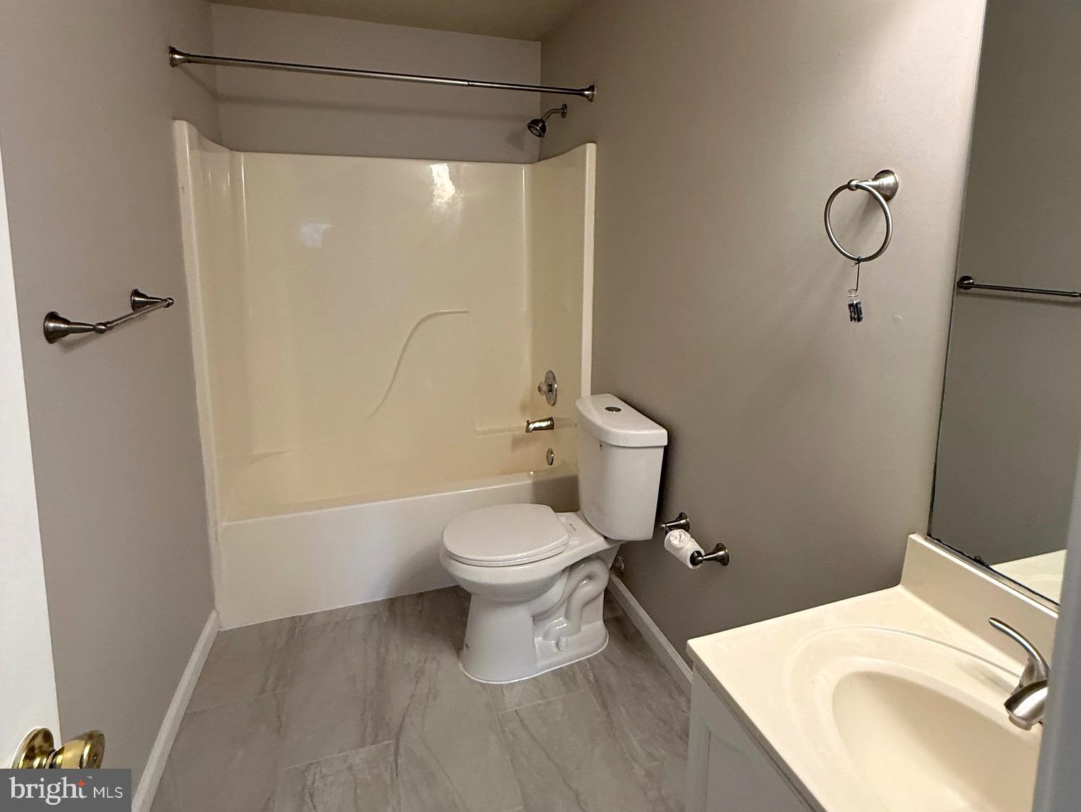 129-8 Brookland Terrace, Unit 8 Winchester, VA 22602 - Photo 9 of 10 a white toilet sitting next to a bathroom sink and a shower