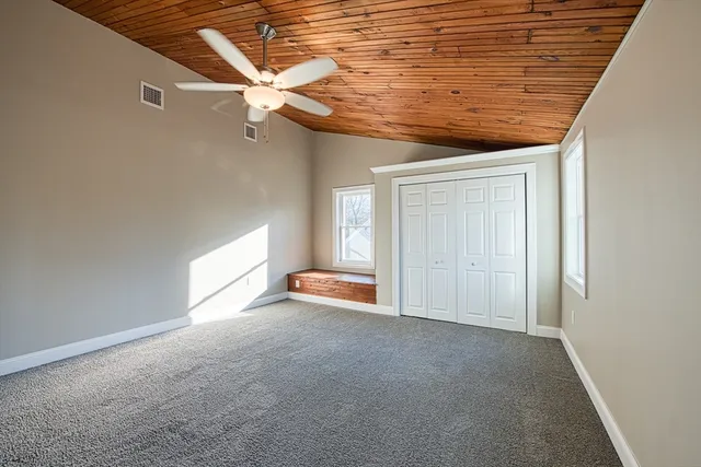 a view of a livingroom with a ceiling fan and window