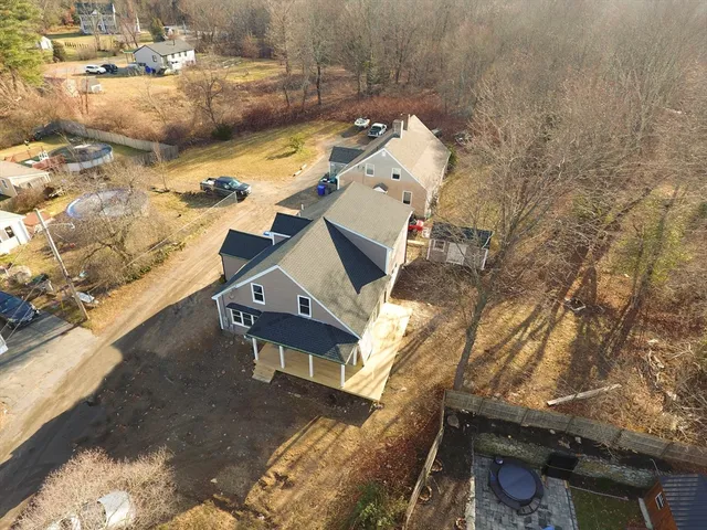 an aerial view of a house with a yard