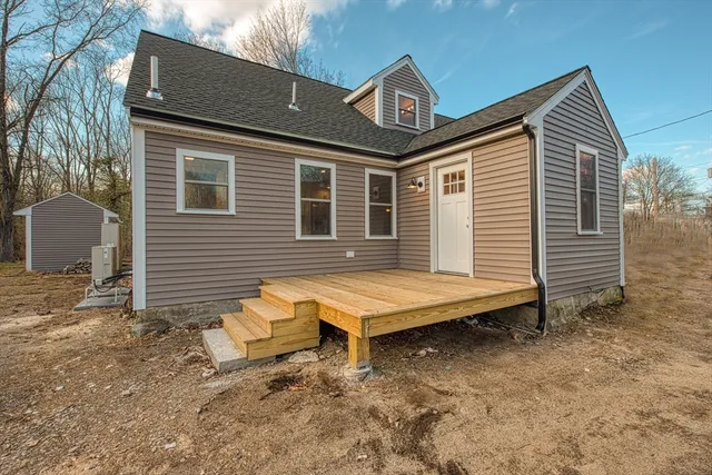 a backyard of a house with table and chairs