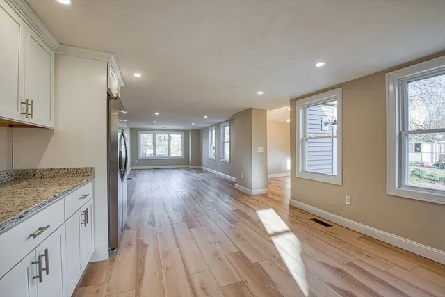 a view of a kitchen with a sink and wooden floor