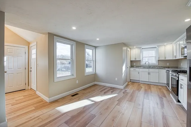 a view of a kitchen with wooden floor and a kitchen