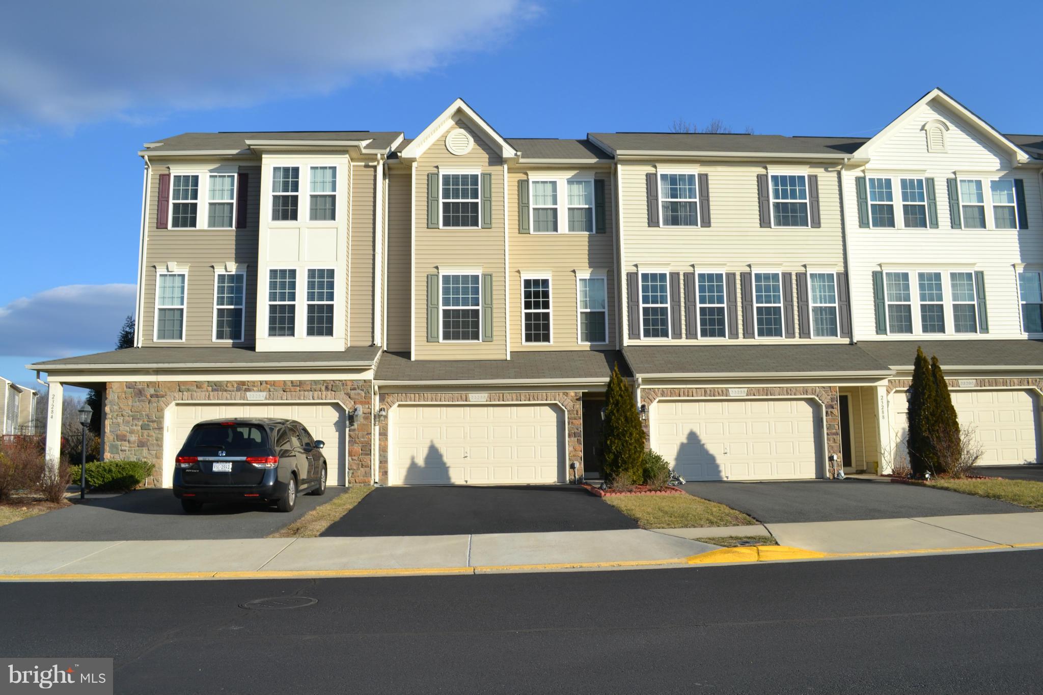 a front view of a residential apartment building with a yard