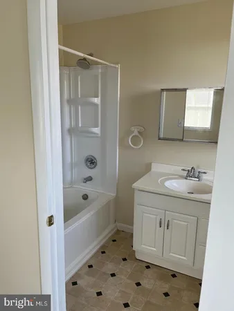 a bathroom with a granite countertop sink a toilet and shower