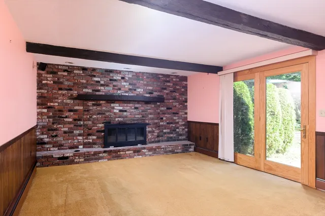 a living room with fireplace and a fireplace
