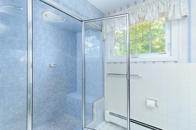 a bathroom with a glass shower door