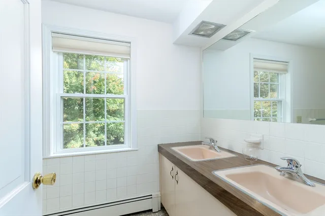 a bathroom with a sink and a window