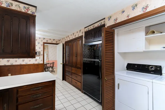a kitchen with a sink a refrigerator and cabinets