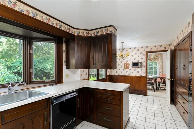 a kitchen with a sink and large cabinets