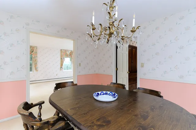 a view of a dining room with furniture and chandelier