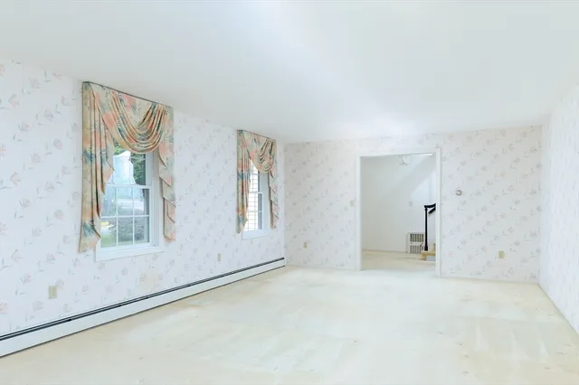 an empty room with windows and closet