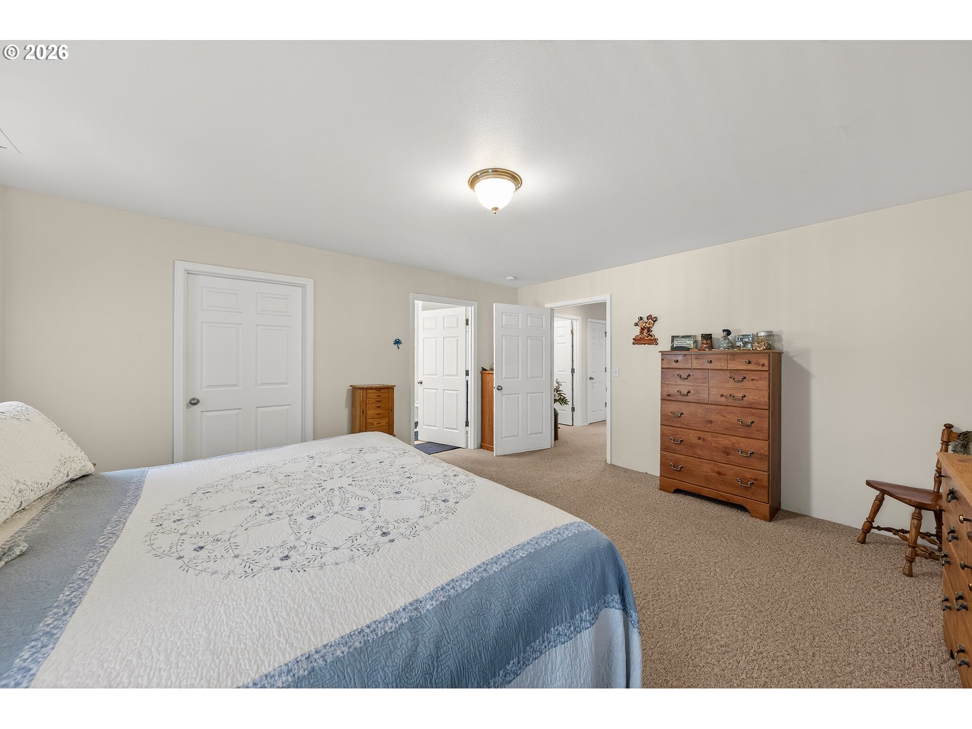 101 Pleasant Street Roseburg, OR 97470 - Photo 16 of 43 a spacious bedroom with a bed and a cabinets