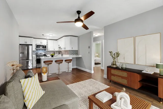 a living room with stainless steel appliances kitchen island granite countertop furniture and a kitchen view