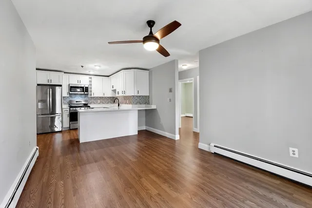 a view of kitchen with refrigerator microwave and stove