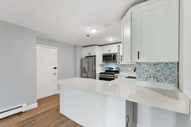 a kitchen with stainless steel appliances a refrigerator stove microwave and cabinets