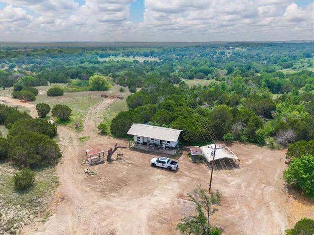 a view of a green field with lots of bushes