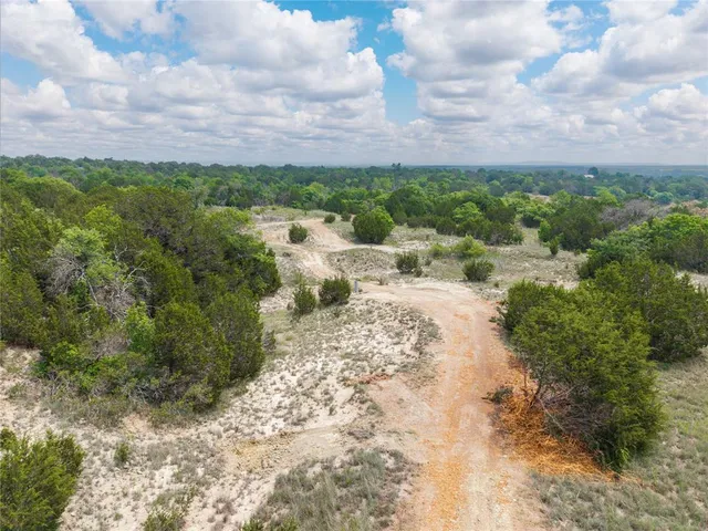 a view of a lake with houses in back
