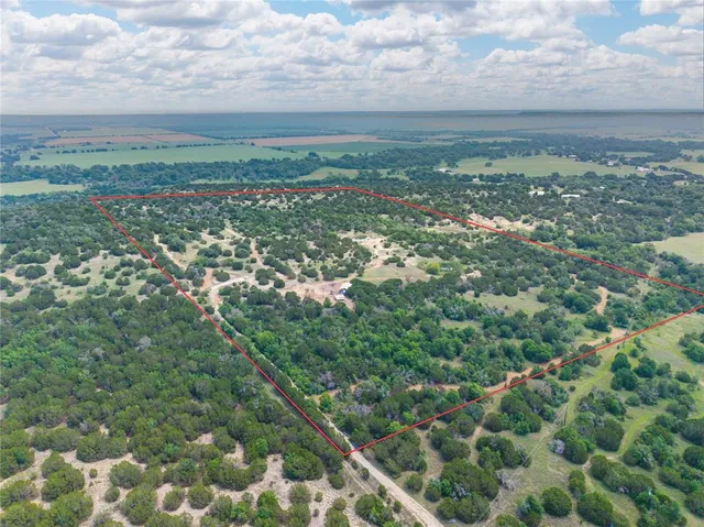 a view of a field with an ocean