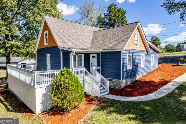 a kitchen with stainless steel appliances a refrigerator a sink dishwasher a stove and white countertops with wooden floor