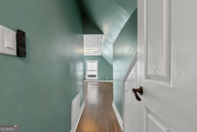 an aerial view of a houses with a lake