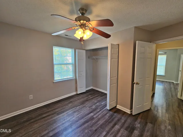 a view of room with window and ceiling fan