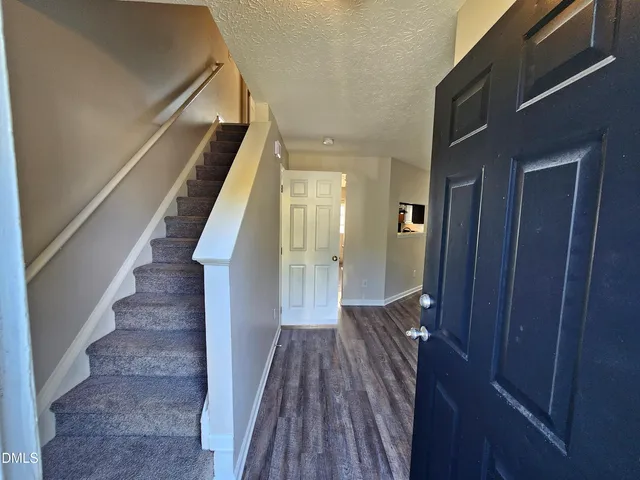a front view of a house with a tree