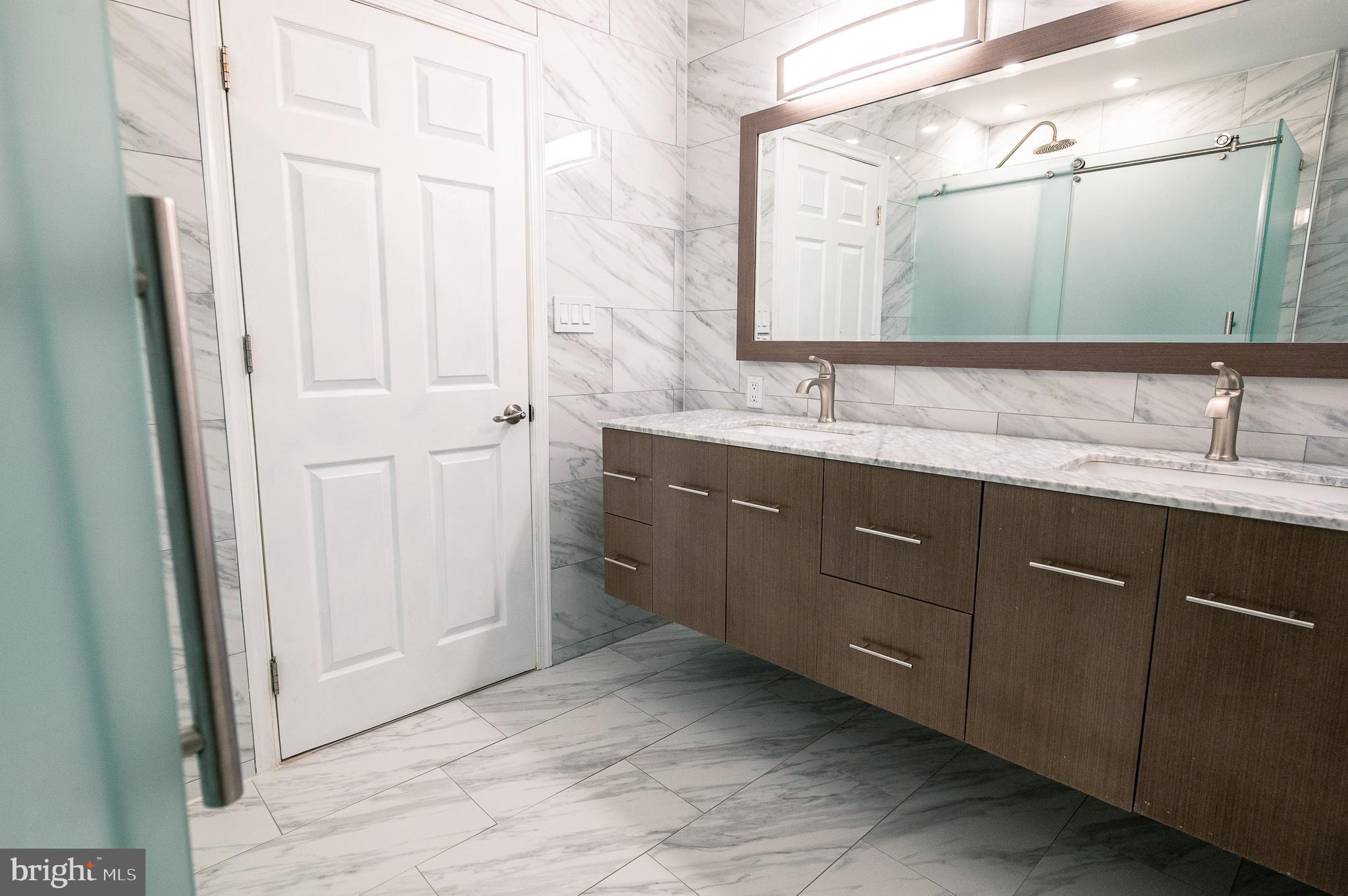 7722 Old York Road Elkins Park, PA 19027 - Photo 22 of 37 a bathroom with a double vanity sink and mirror
