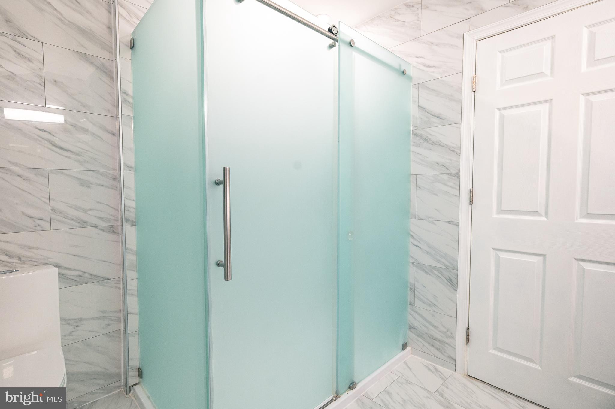 7722 Old York Road Elkins Park, PA 19027 - Photo 23 of 37 a bathroom with a shower and a glass door