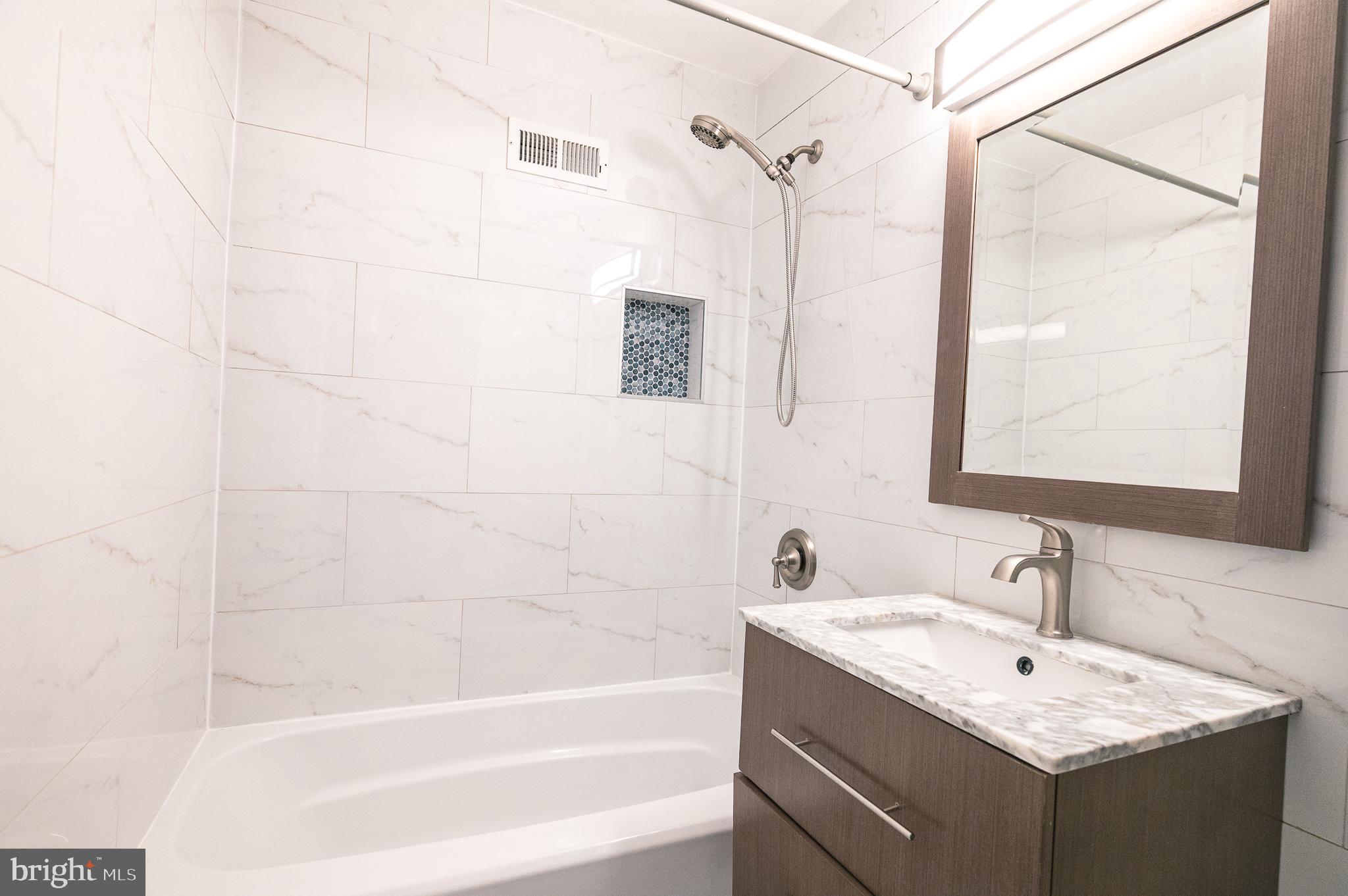 7722 Old York Road Elkins Park, PA 19027 - Photo 29 of 37 a bathroom with a granite countertop sink toilet and shower