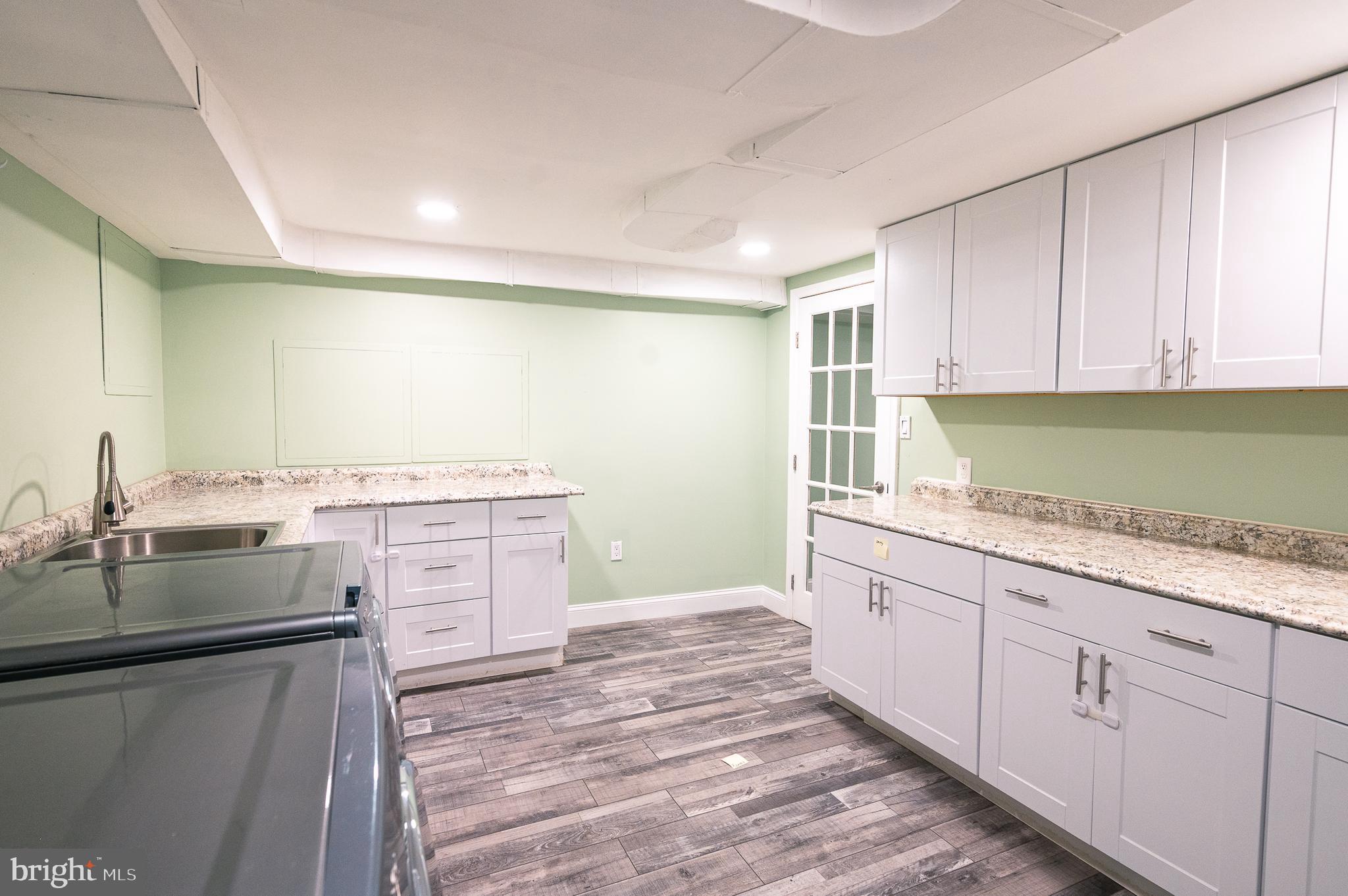 7722 Old York Road Elkins Park, PA 19027 - Photo 35 of 37 a kitchen with granite countertop white cabinets and stainless steel appliances