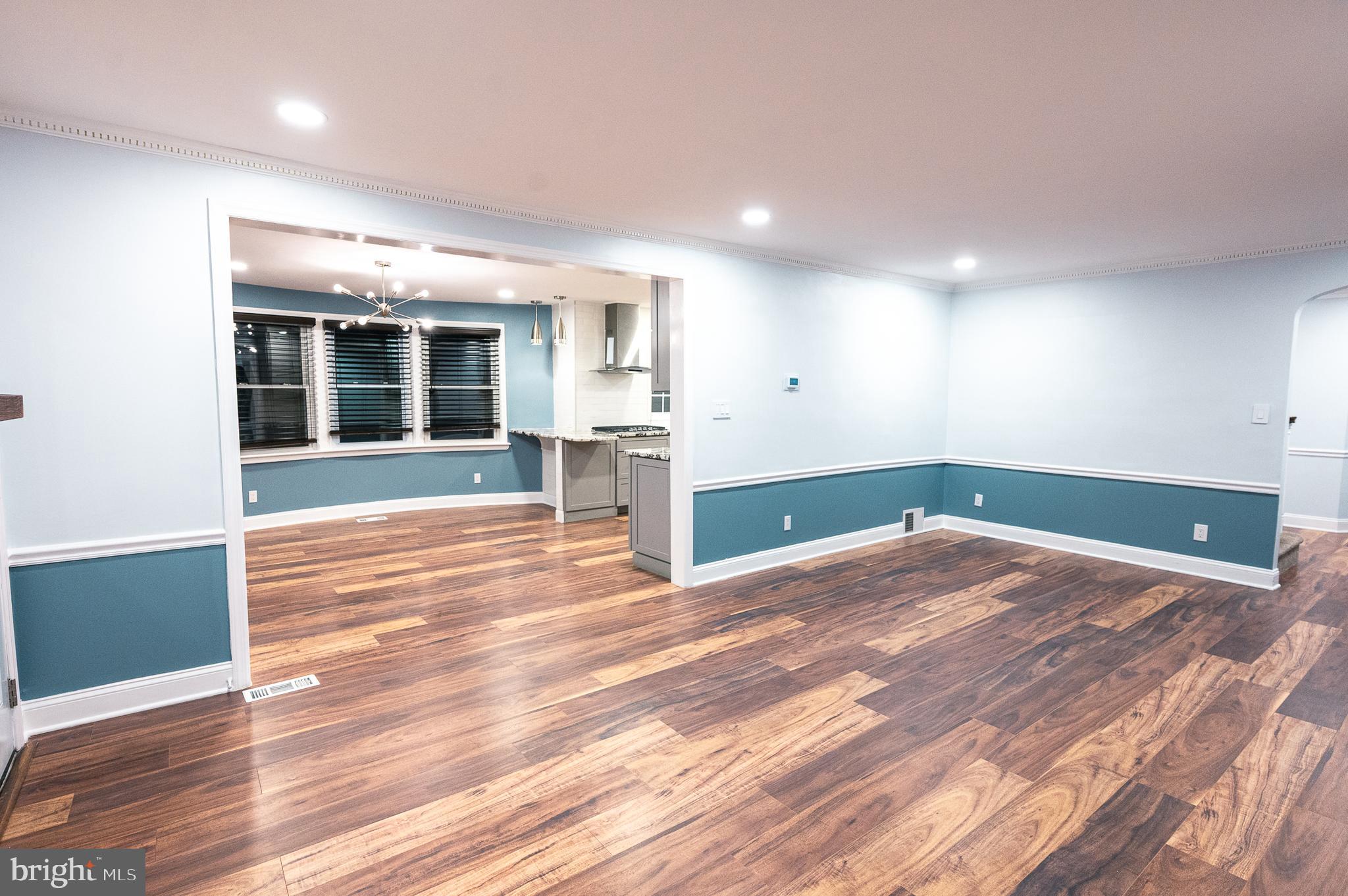 7722 Old York Road Elkins Park, PA 19027 - Photo 5 of 37 an empty room with wooden floor and fireplace
