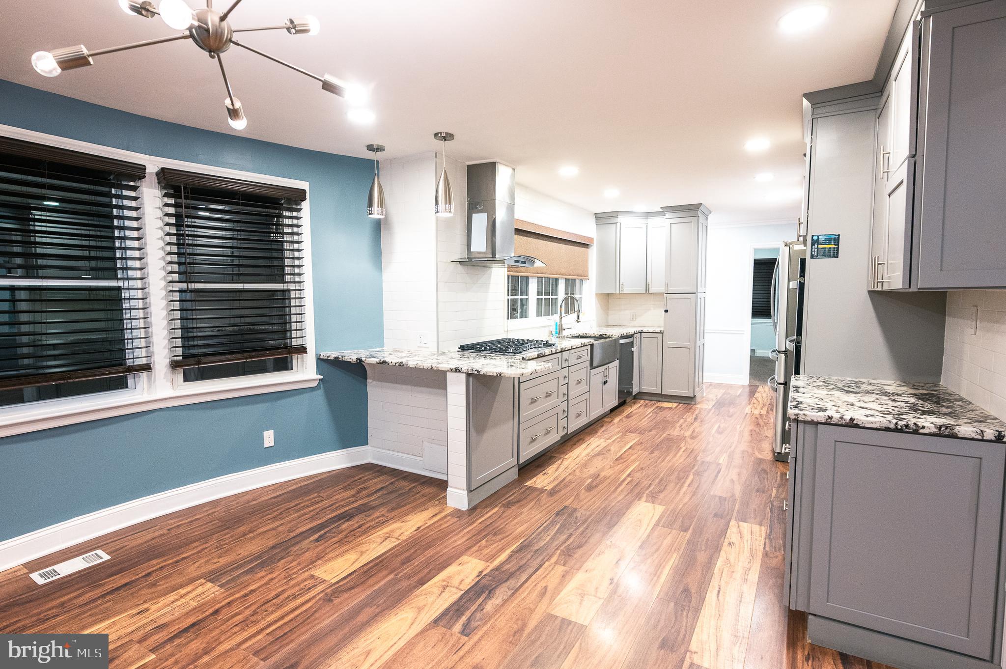 7722 Old York Road Elkins Park, PA 19027 - Photo 6 of 37 a large kitchen with stainless steel appliances kitchen island granite countertop a stove a sink and a refrigerator