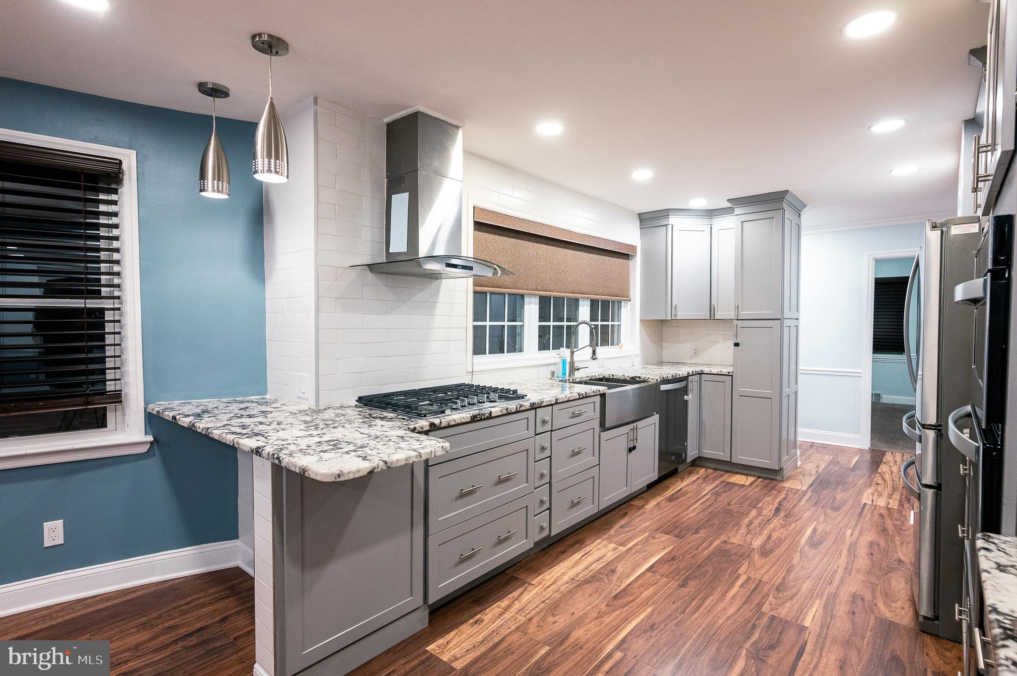 7722 Old York Road Elkins Park, PA 19027 - Photo 7 of 37 a kitchen with a stove a sink and a refrigerator