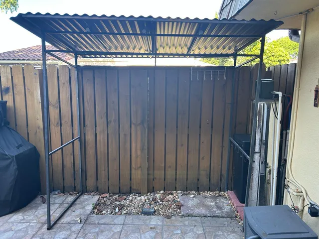 a view of a backyard with wooden fence