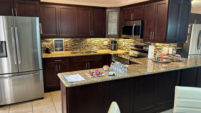 a kitchen with a sink refrigerator and cabinets