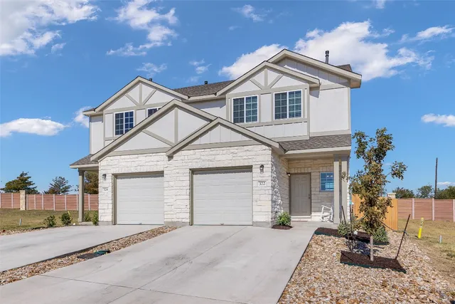 a view of a yard in front view of a house