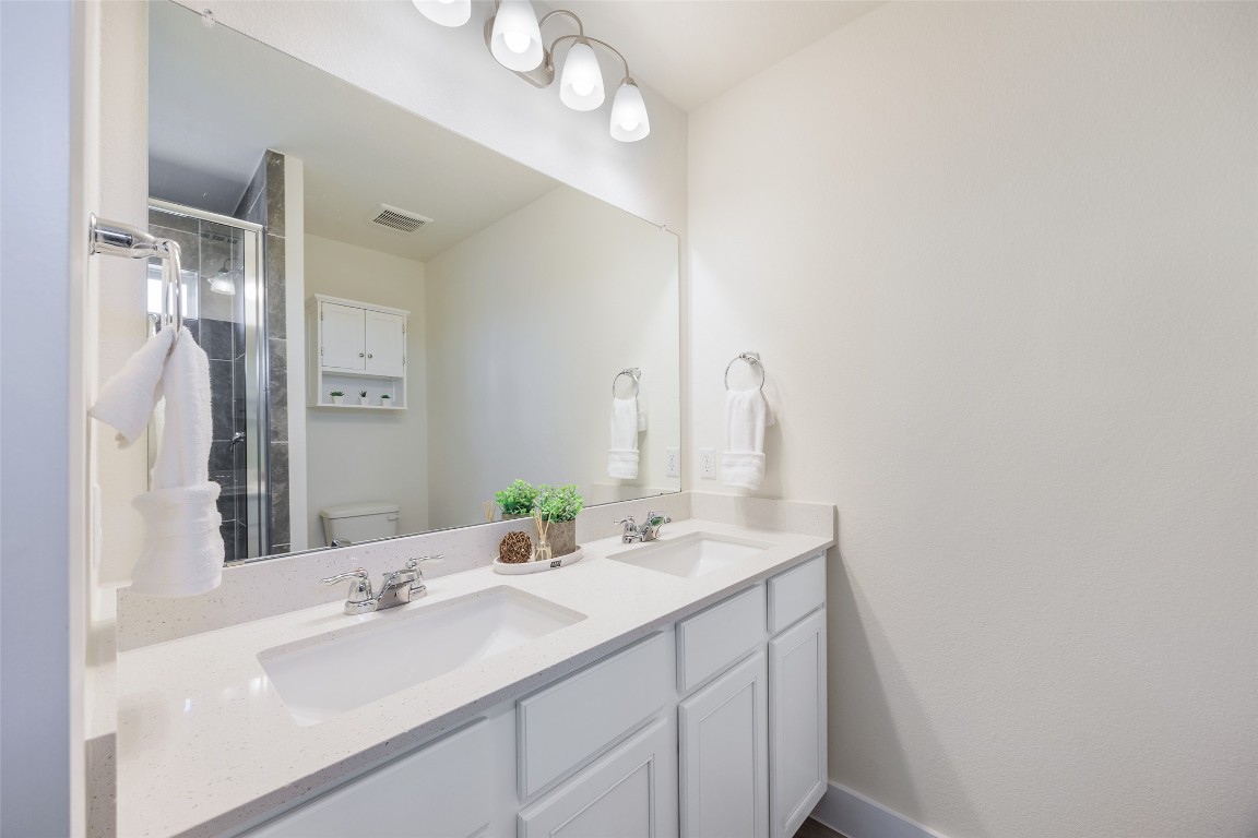 322 Furlong Drive Georgetown, TX 78626 - Photo 11 of 23 a bathroom with a sink vanity granite and a mirror